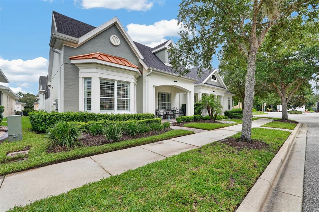A gray house with a copper-roofed bay window and a covered front porch — 3434 TORRE BOULEVARD, NEW SMYRNA BEACH, FL