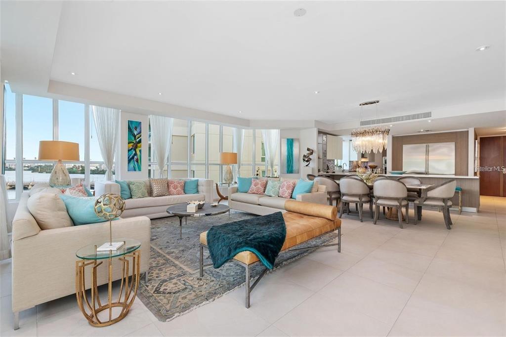A bright, open-concept living and dining area features floor-to-ceiling windows and modern neutral furniture — 25 MUÑOZ RIVERA AVE UNIT 614, SAN JUAN, PR