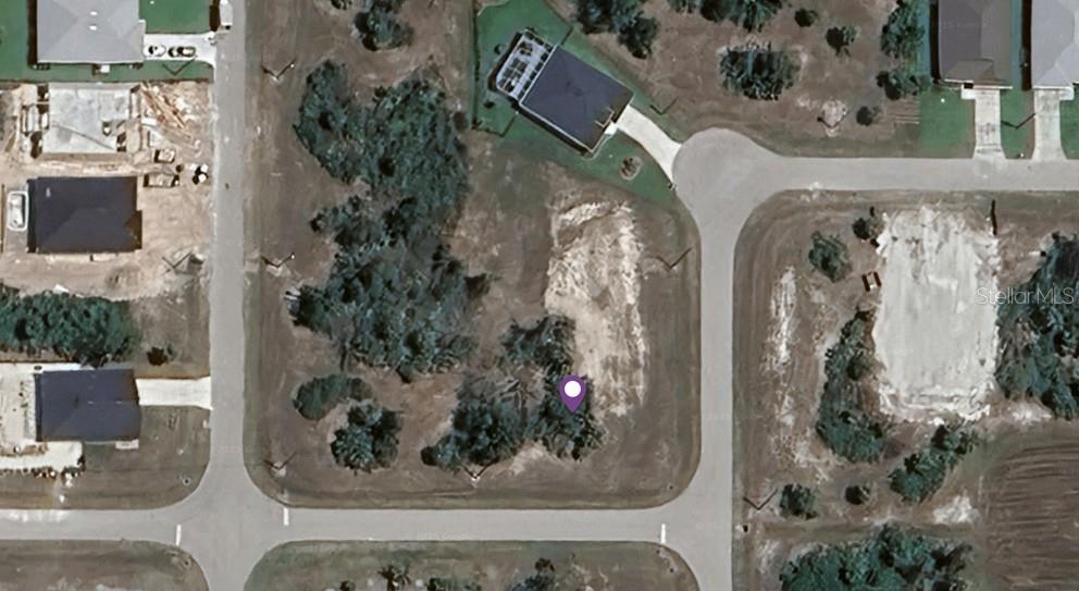 This aerial map view shows a vacant residential lot surrounded by roads and nearby houses — 128 RED CEDAR PARK, ROTONDA WEST, FL