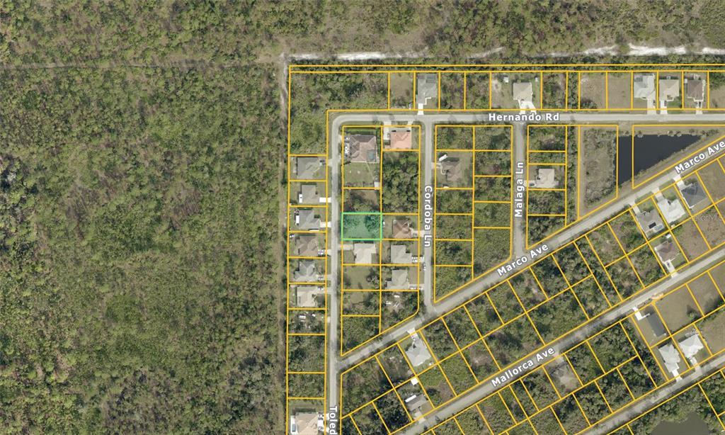 This is an aerial map showing a highlighted vacant lot within a residential neighborhood — TOLEDO ROAD, NORTH PORT, FL
