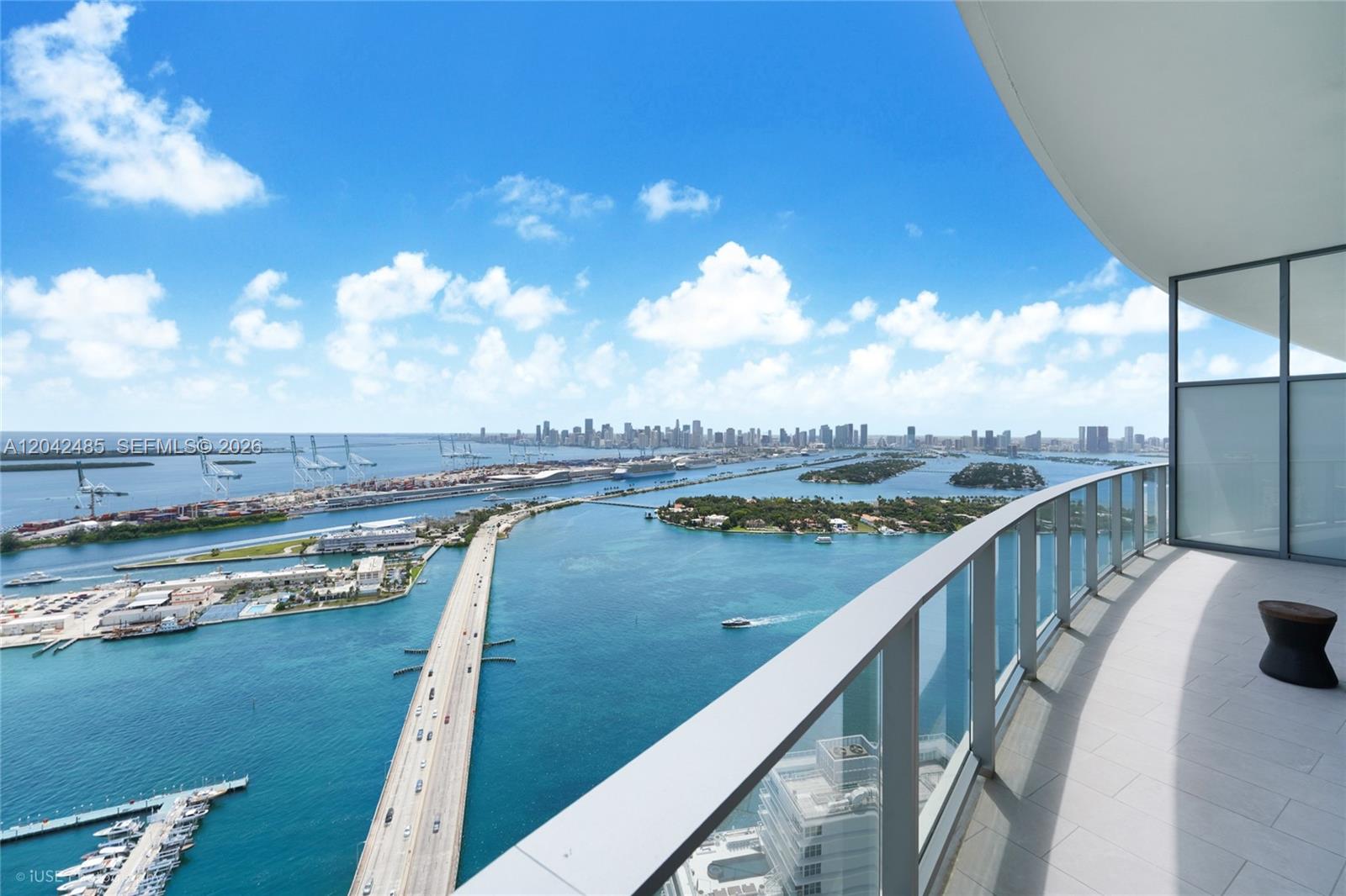 A high-rise balcony overlooks a bridge, the ocean, and a distant city skyline — 500 Alton Rd # 4401, Miami Beach FL 33139, MIAMI BEACH, FL