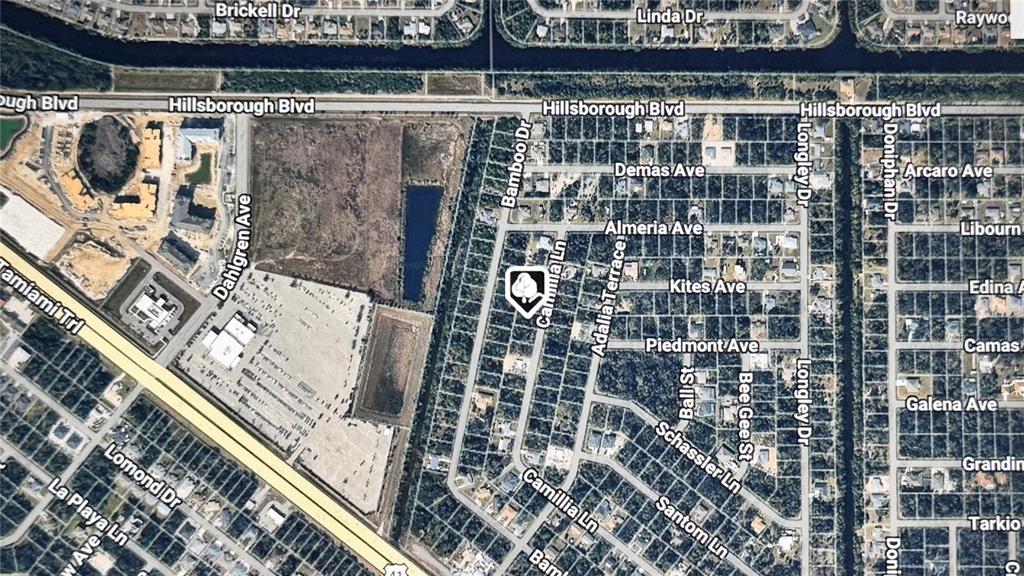 This is an aerial map view showing a residential neighborhood and adjacent undeveloped land — 109 CAMILLIA LANE, PORT CHARLOTTE, FL