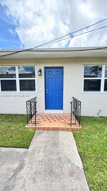A blue front door with the number three is centered on a tan exterior wall — 3085 W Flagler St # 3, Miami FL 33135, MIAMI, FL