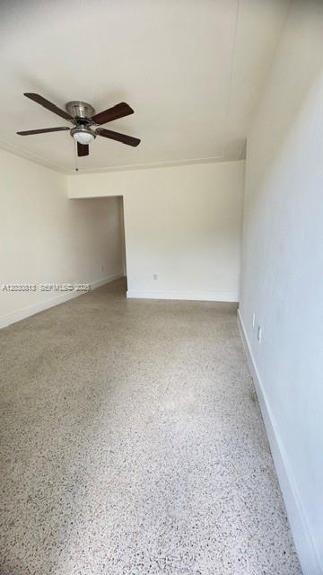 An empty room features a ceiling fan, white walls, and light-colored speckled flooring — 3085 W Flagler St # 3, Miami FL 33135, MIAMI, FL