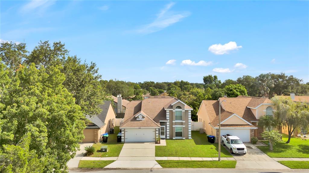 An aerial view shows a suburban house with a brown roof and a concrete driveway — 2235 MEADOWMOUSE STREET, ORLANDO, FL