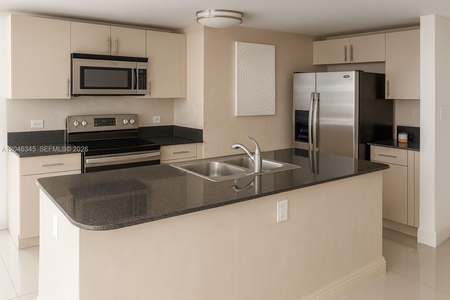 A kitchen features beige cabinets, black granite countertops, stainless steel appliances, and a central island — 1861 NW S River Dr # 1505, Miami FL 33125, MIAMI, FL