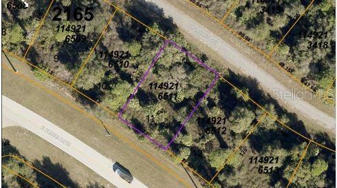 This aerial map shows a vacant, wooded residential lot outlined in purple — HAMPSHIRE CIRCLE, NORTH PORT, FL