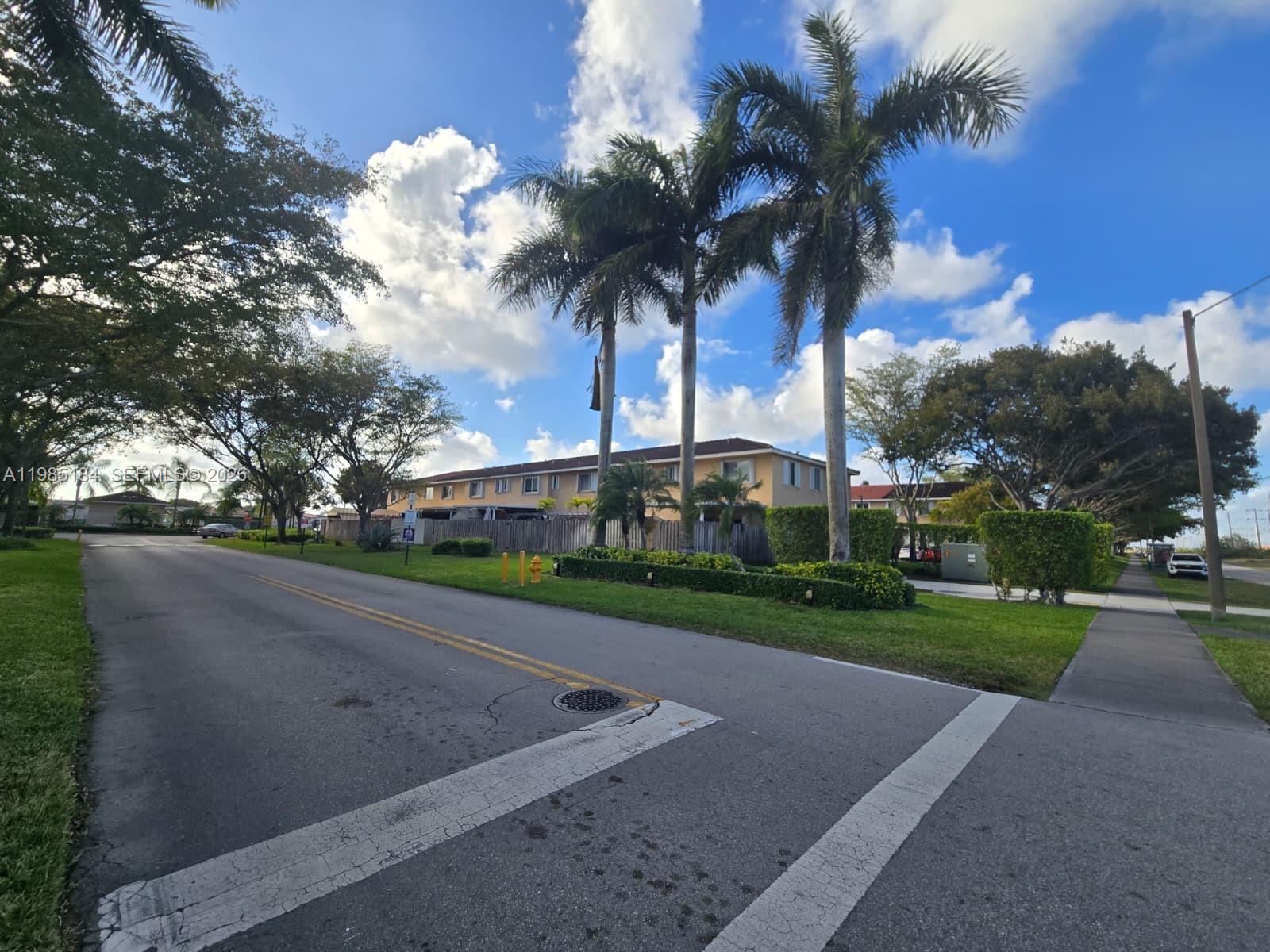 A street view shows a multi-story apartment building with palm trees and a grassy lawn — 13926 SW 175th Ter, Miami FL 33177, MIAMI, FL