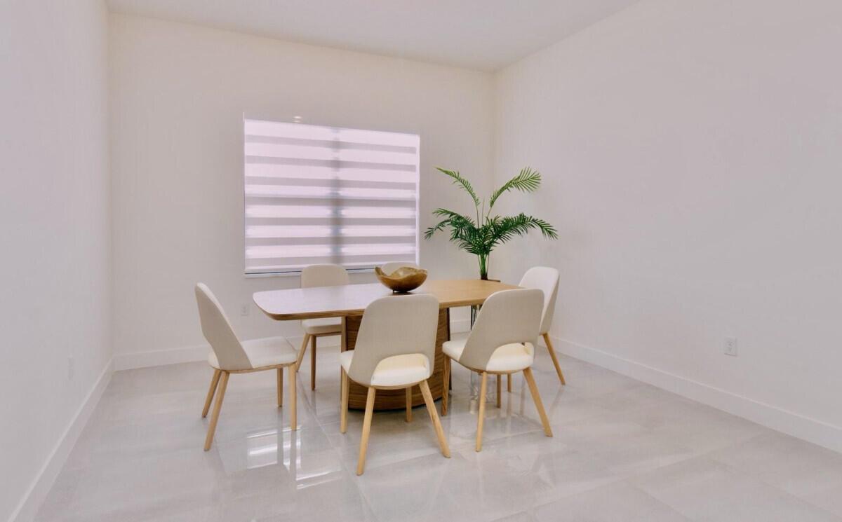 A dining room with a wooden table, five chairs, a plant, and light-colored tile flooring — 17451 SW 41st Street, Miramar FL 33029, MIRAMAR, FL