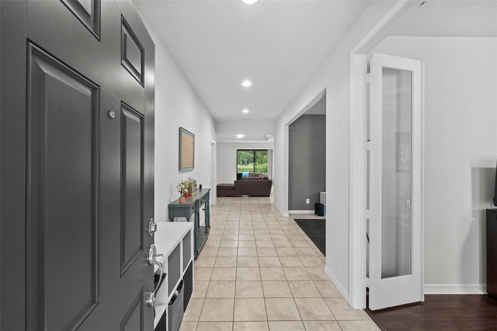 A tiled entryway leads into a home with a view of a distant living room — 2212 LANDSIDE DRIVE, VALRICO, FL