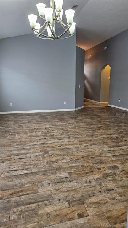 A concrete walkway leads to a front door with a white screen door and garage — 2713 BARNSLEY LANE, KISSIMMEE, FL