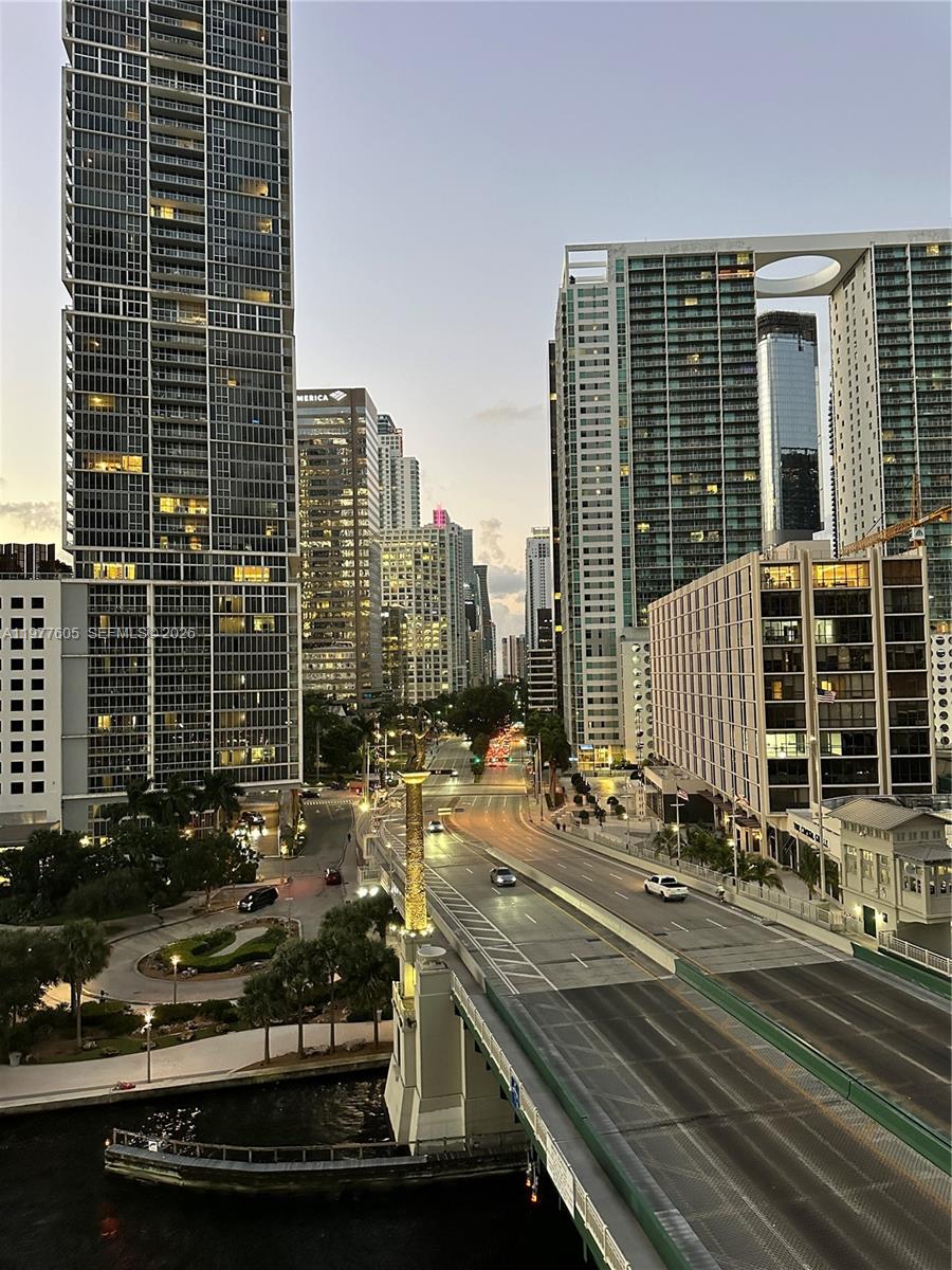 An elevated view of a city street with a bridge, tall skyscrapers, and a river — 200 S Biscayne Boulevard Way # 703, Miami FL 33131, MIAMI, FL