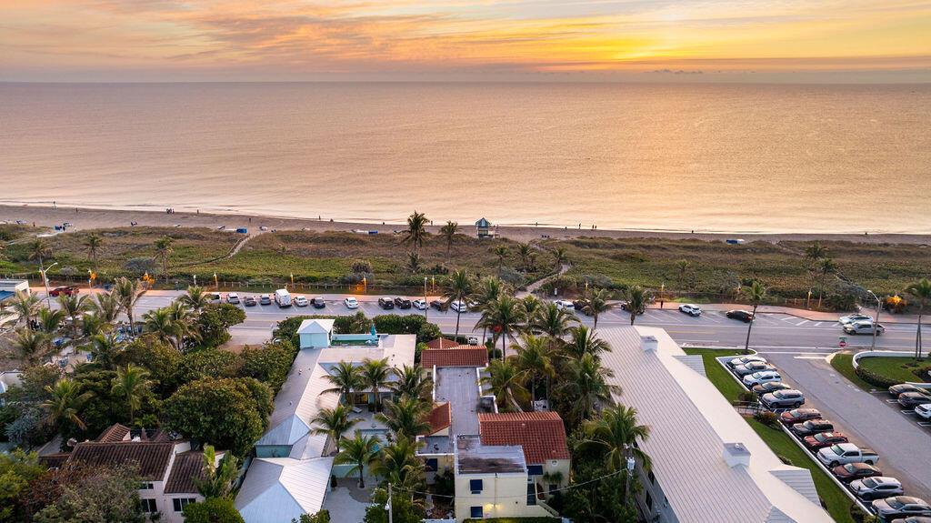 An aerial view shows a coastal property with a pool, palm trees, and beach access — 88 S Ocean Boulevard, Delray Beach FL 33483, DELRAY BEACH, FL
