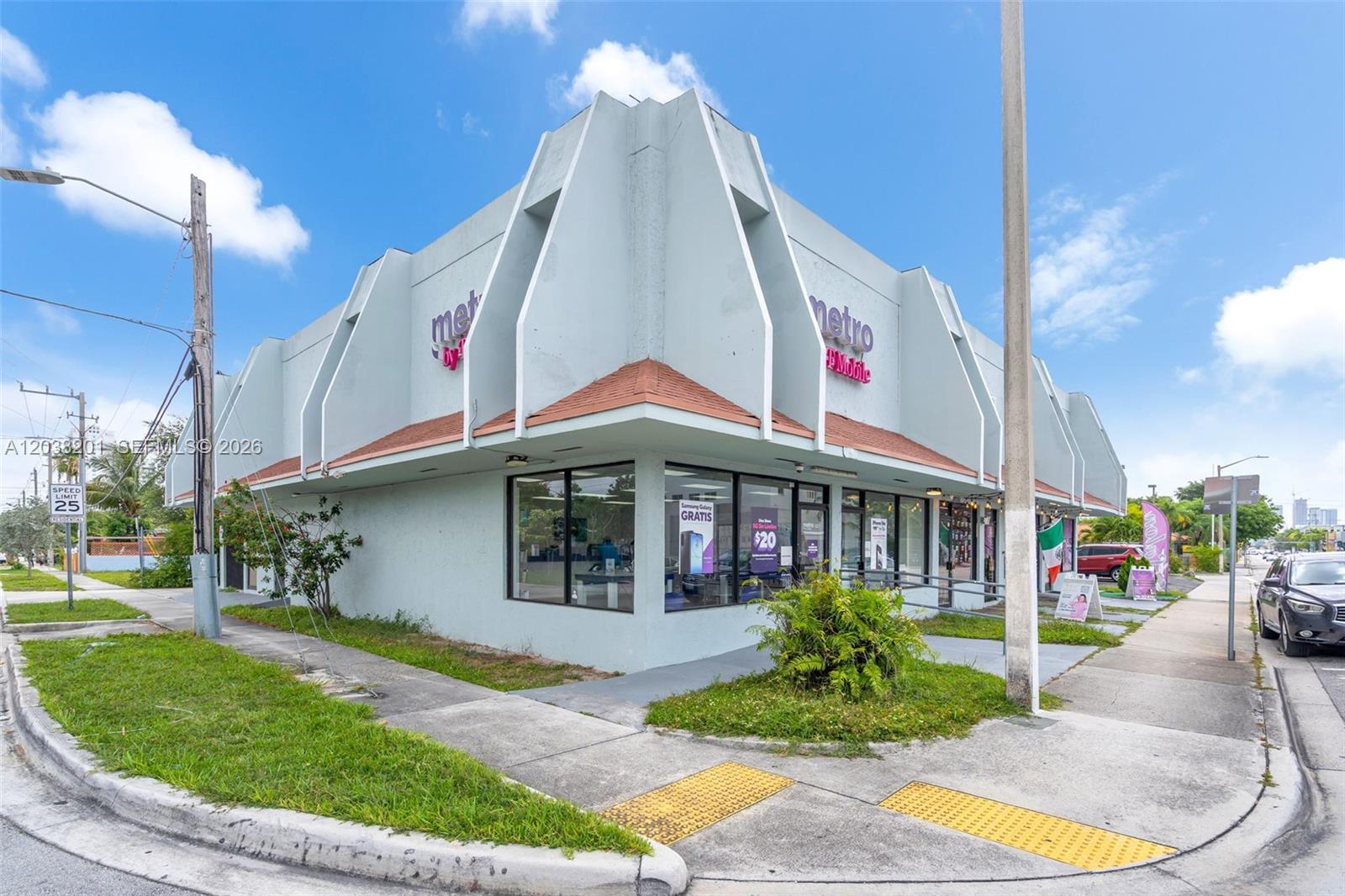 A corner commercial building with a light blue exterior and a Metro by T-Mobile sign — 1879 NW 7th St, Miami FL 33125, MIAMI, FL