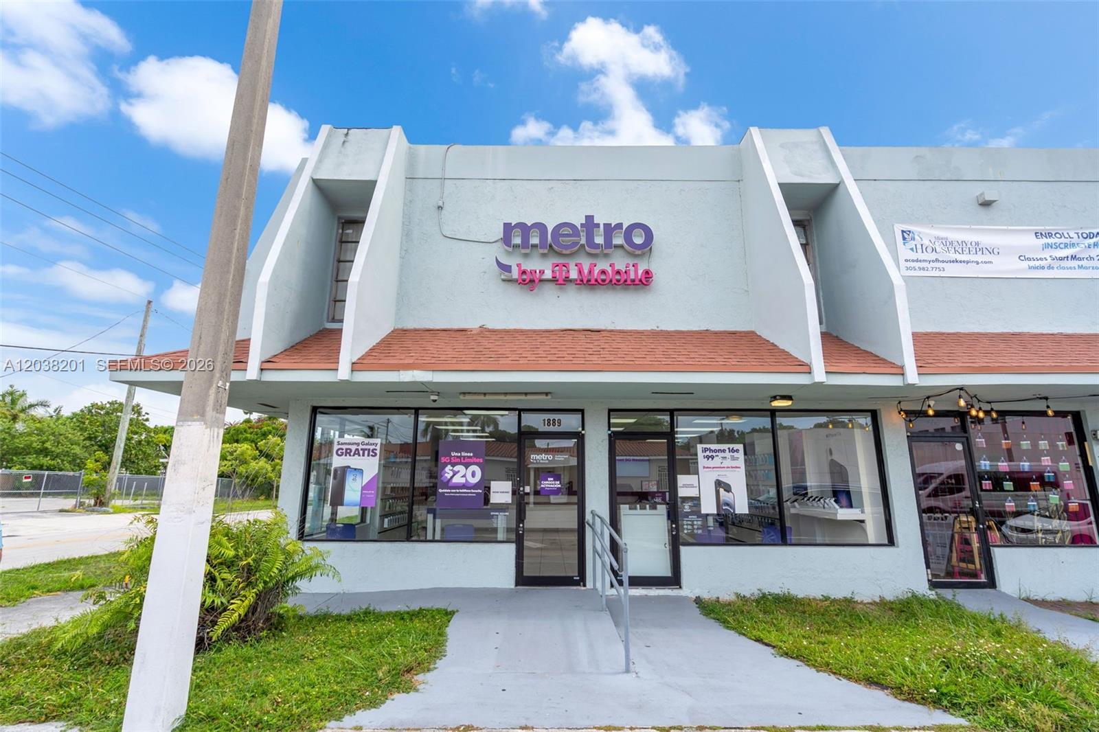 A street-level view of a Metro by T-Mobile storefront with a light blue facade — 1879 NW 7th St, Miami FL 33125, MIAMI, FL