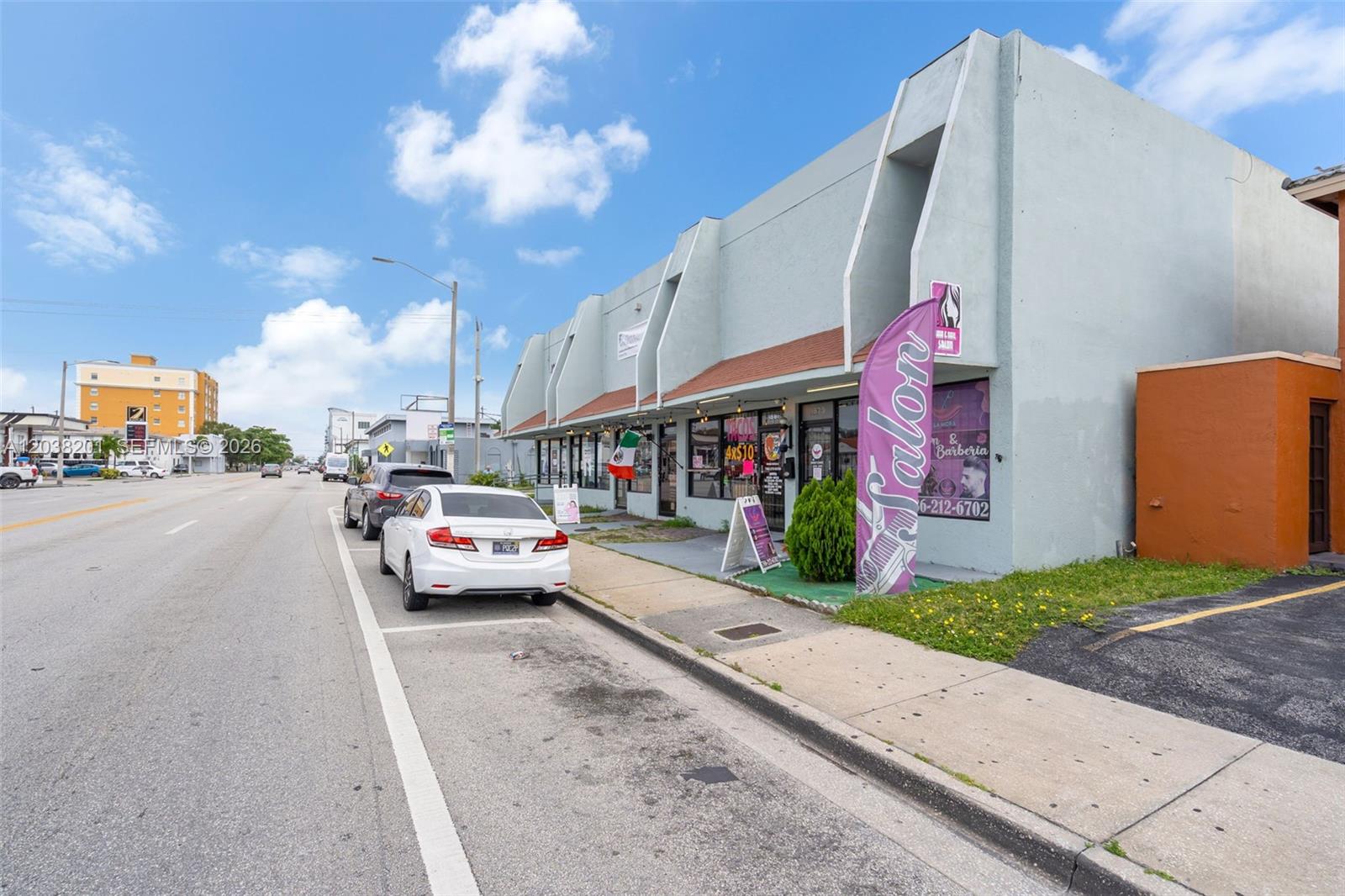 A light-colored commercial building with a salon and barber shop sits along a street — 1879 NW 7th St, Miami FL 33125, MIAMI, FL