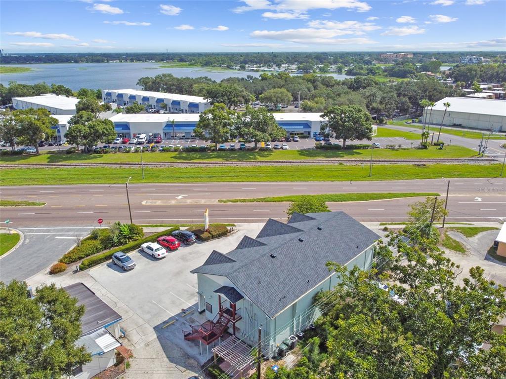 An aerial view shows a commercial building with a parking lot next to a highway — 1137 BARTOW ROAD UNIT 206, LAKELAND, FL