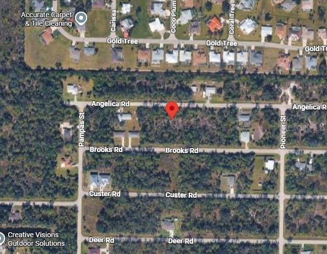 This is an aerial map view of a wooded residential lot marked with a pin — 26215 ANGELICA ROAD, PUNTA GORDA, FL