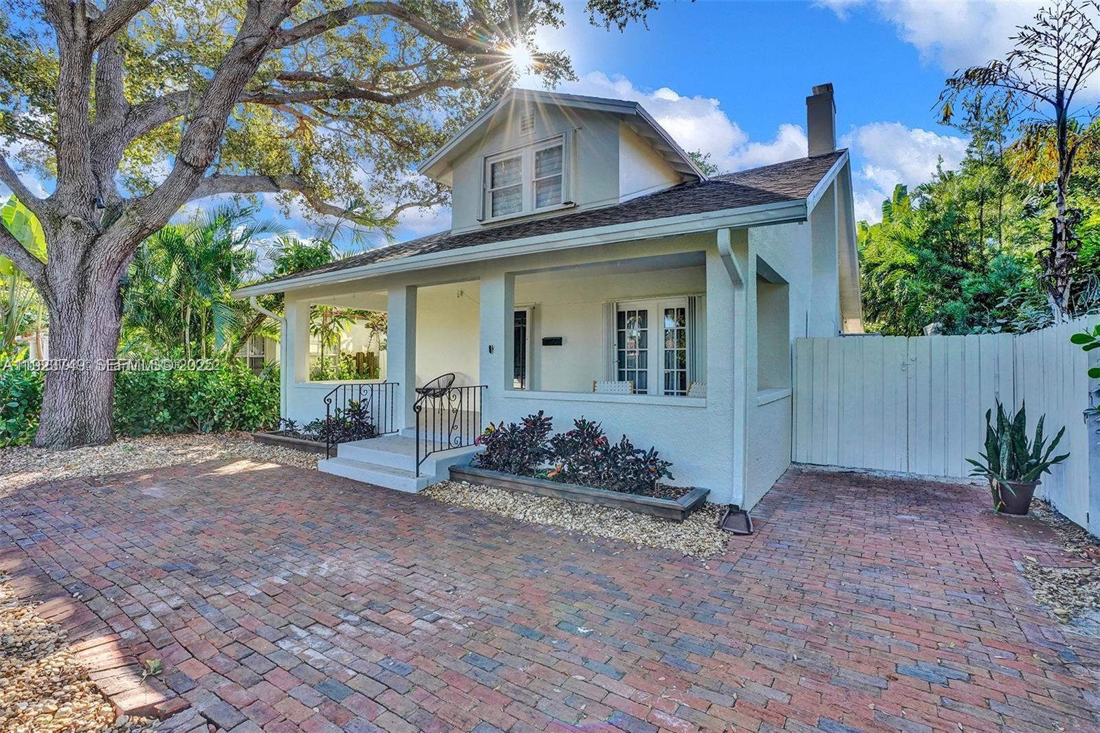 A single-story house with a brick driveway, a front porch, and a large tree — 1640 Jefferson St, Hollywood FL 33020, HOLLYWOOD, FL