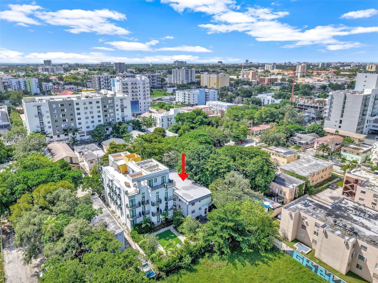An aerial view shows a multi-story apartment building next to a smaller, flat-roofed residential structure — 641 NW 2nd St, Miami FL 33128, MIAMI, FL