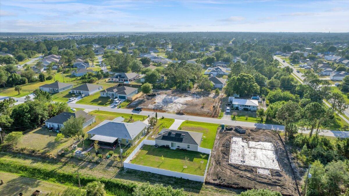 An aerial view shows a residential neighborhood with several houses, a vacant lot, and construction — 3129 Wessel Avenue SE, Palm Bay FL 32909, PALM BAY, FL