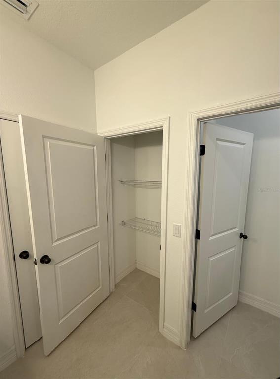 A hallway features two white interior doors and an open closet with wire shelving — 2190 W ARBUTUS DRIVE, CITRUS SPRINGS, FL