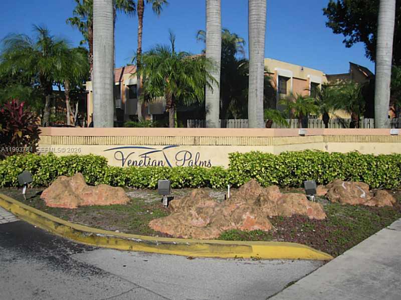 A stone sign for Venetian Palms stands in front of palm trees and apartment buildings — 7913 SW 104th St # G207, Miami FL 33156, MIAMI, FL
