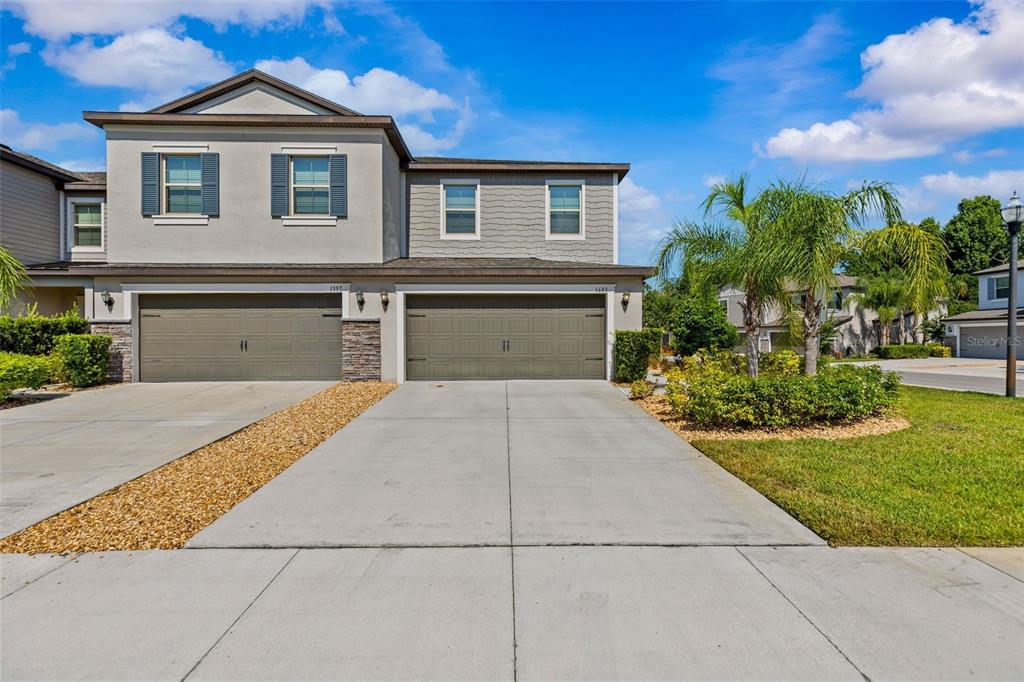A living room and dining area with tile floors, neutral walls, and a ceiling fan — 1603 ROSEVILLE STREET, LUTZ, FL