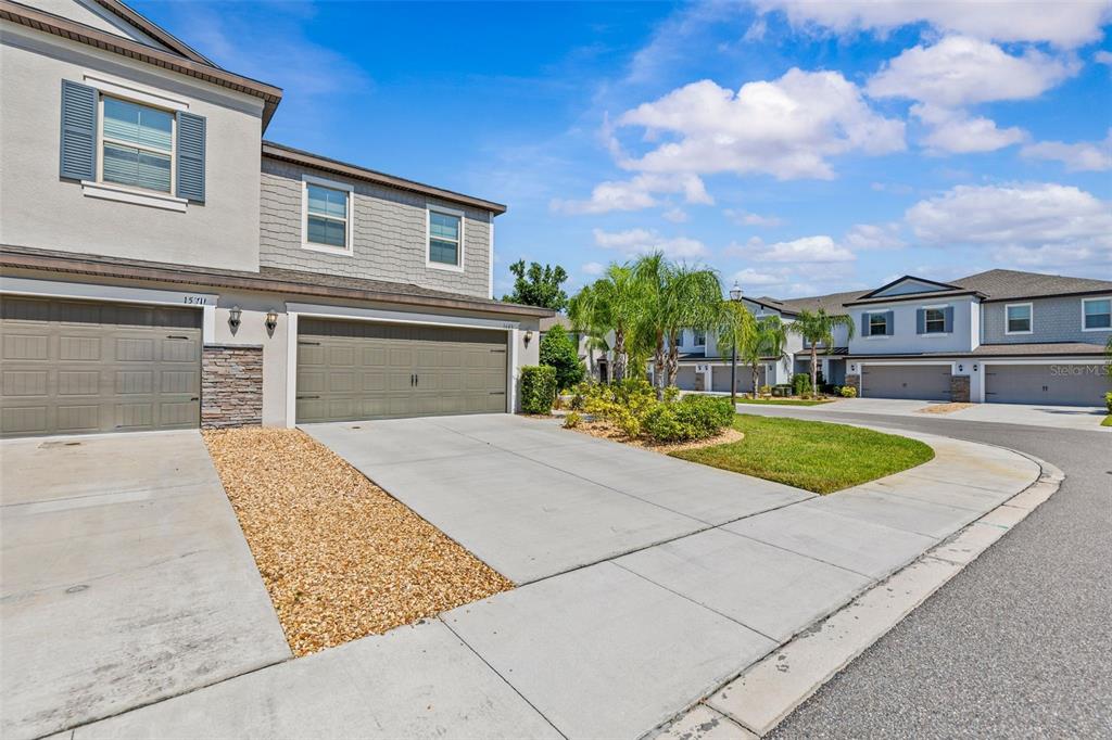 A dining area with a round table and chairs sits before an open-concept kitchen — 1603 ROSEVILLE STREET, LUTZ, FL