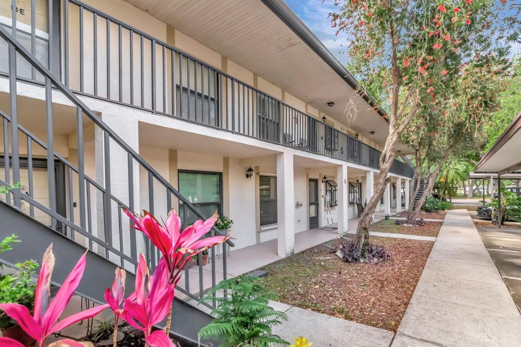 An exterior view of a two-story apartment building with a metal staircase and balcony — 11511 113TH STREET UNIT 13F, LARGO, FL