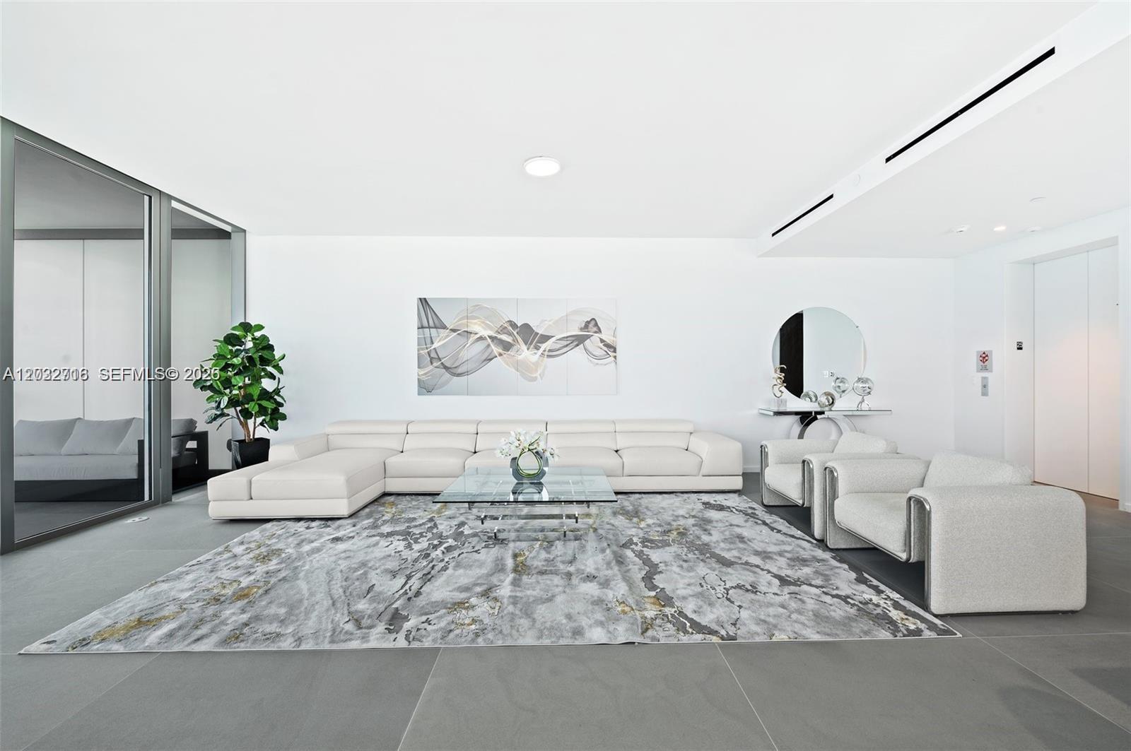 A modern living room features a white sectional sofa, glass coffee table, and area rug — 2000 S Ocean Dr # 25A, Hallandale Beach FL 33009, HALLANDALE BEACH, FL