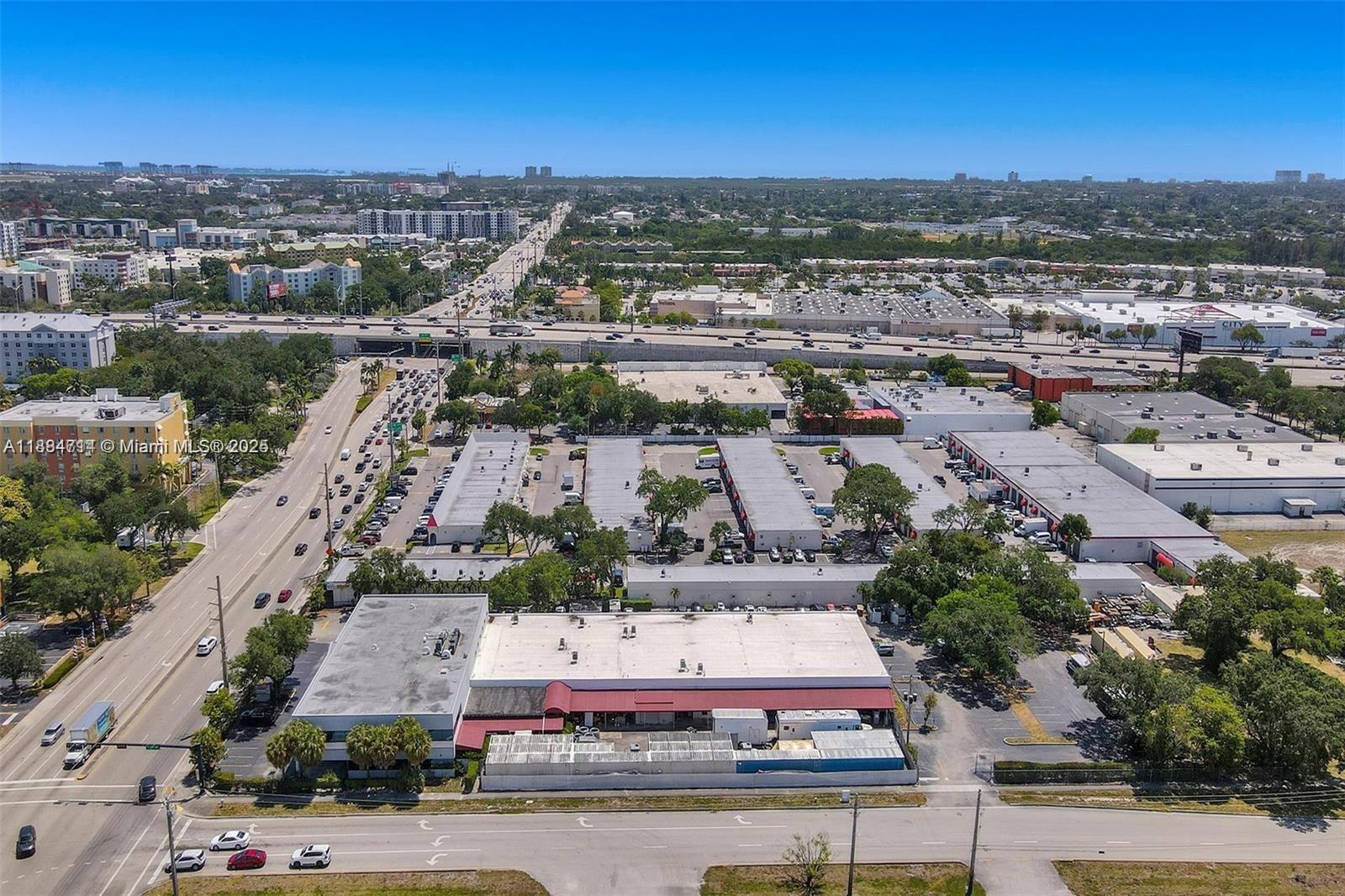 An aerial view shows a commercial warehouse complex with parking lots near a busy highway — 2870 Stirling Rd, Hollywood FL 33020, HOLLYWOOD, FL