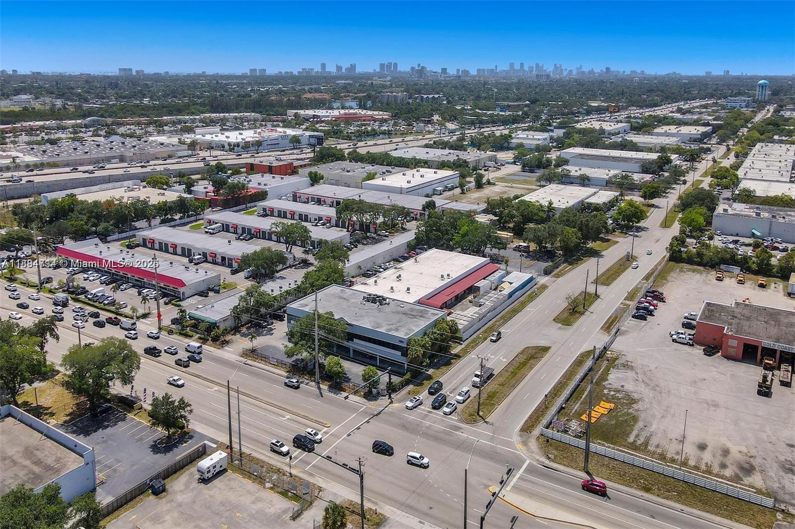 An aerial view shows industrial buildings, parking lots, and roads in a suburban area — 2870 Stirling Rd, Hollywood FL 33020, HOLLYWOOD, FL