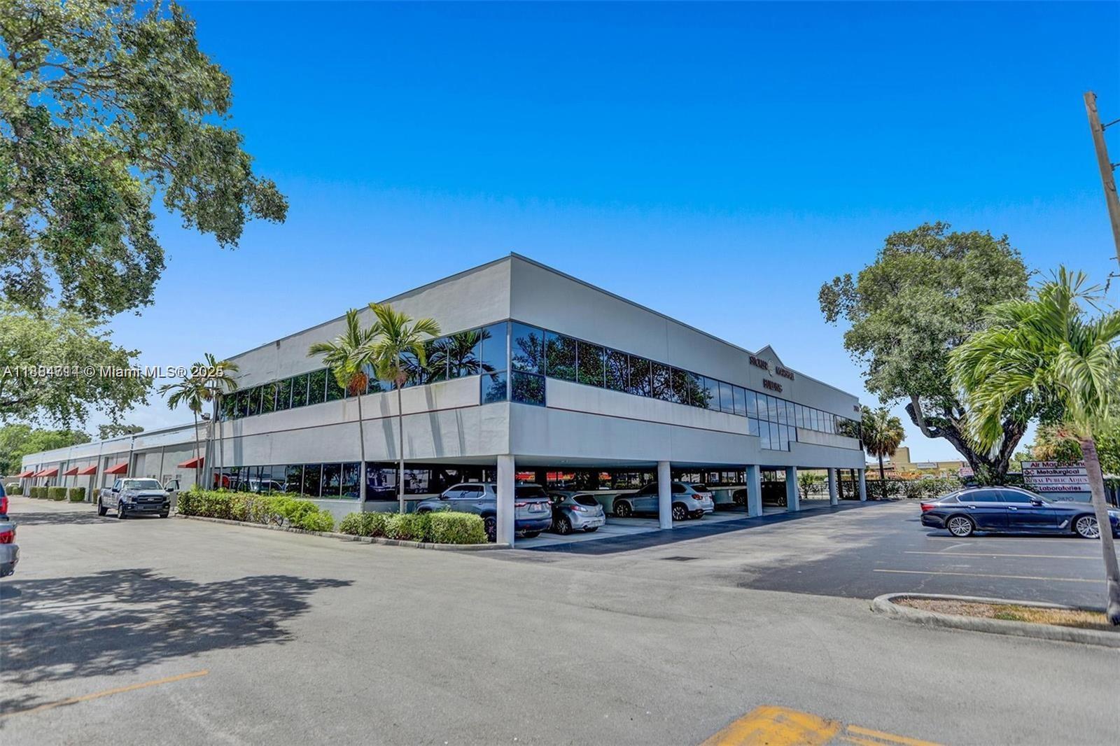 A two-story commercial office building with a ground-level parking area and surrounding trees — 2870 Stirling Rd, Hollywood FL 33020, HOLLYWOOD, FL