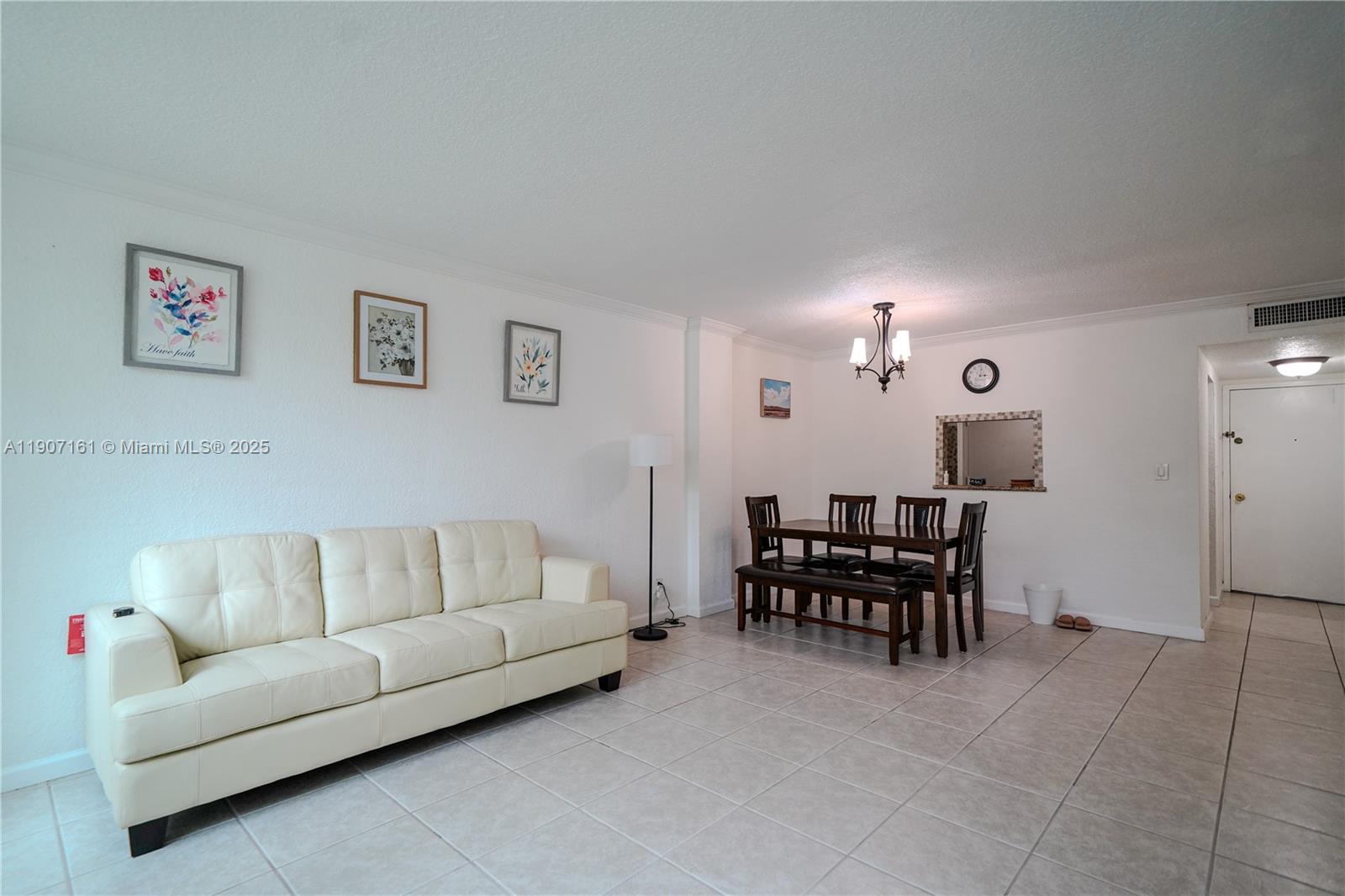 A living and dining area features white walls, tile flooring, and a cream-colored sofa — 9125 SW 77th Ave # 103, Miami FL 33156, MIAMI, FL