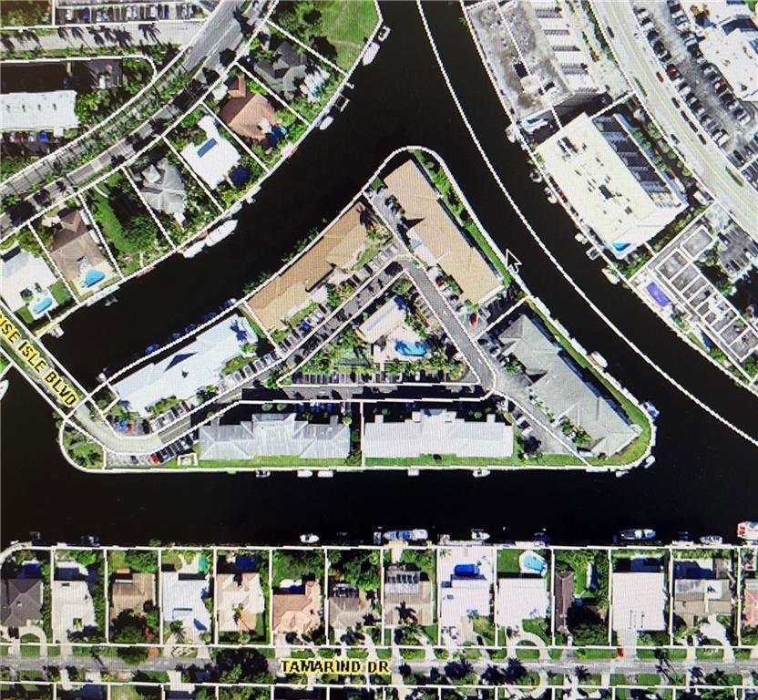 This aerial map shows a triangular residential complex surrounded by canals and nearby homes — 450 Paradise Isle Boulevard, Hallandale Beach FL 33009, HALLANDALE BEACH, FL