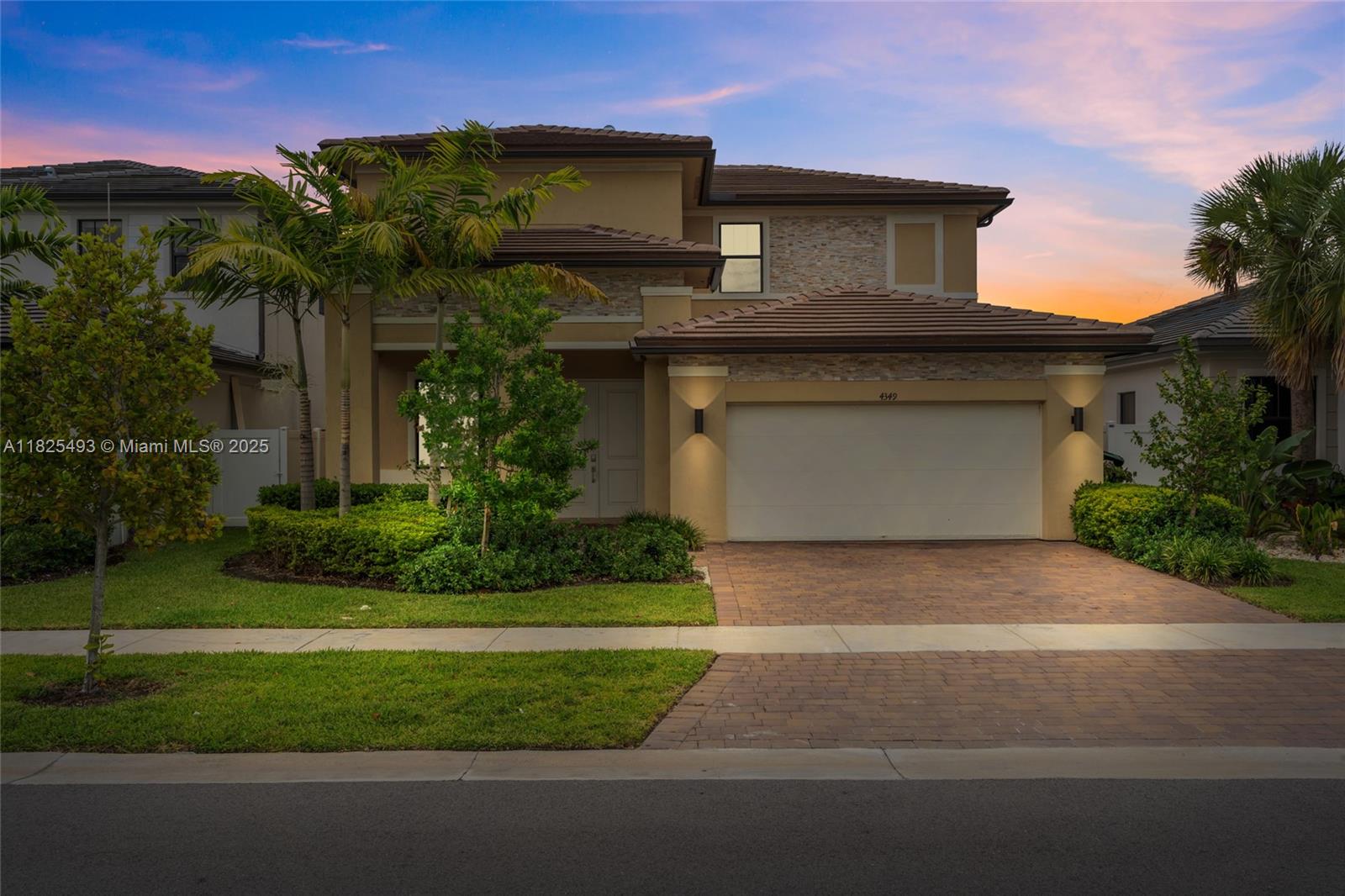 A two-story suburban house features a stone facade, a two-car garage, and a paved driveway — 4349 SW 173rd Ave, Miramar FL 33029, MIRAMAR, FL