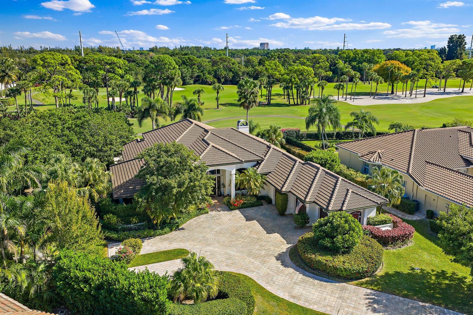 An aerial view shows a house with a tiled roof and a circular paved driveway — 8010 Fairway Lane, West Palm Beach FL 33412, WEST PALM BEACH, FL