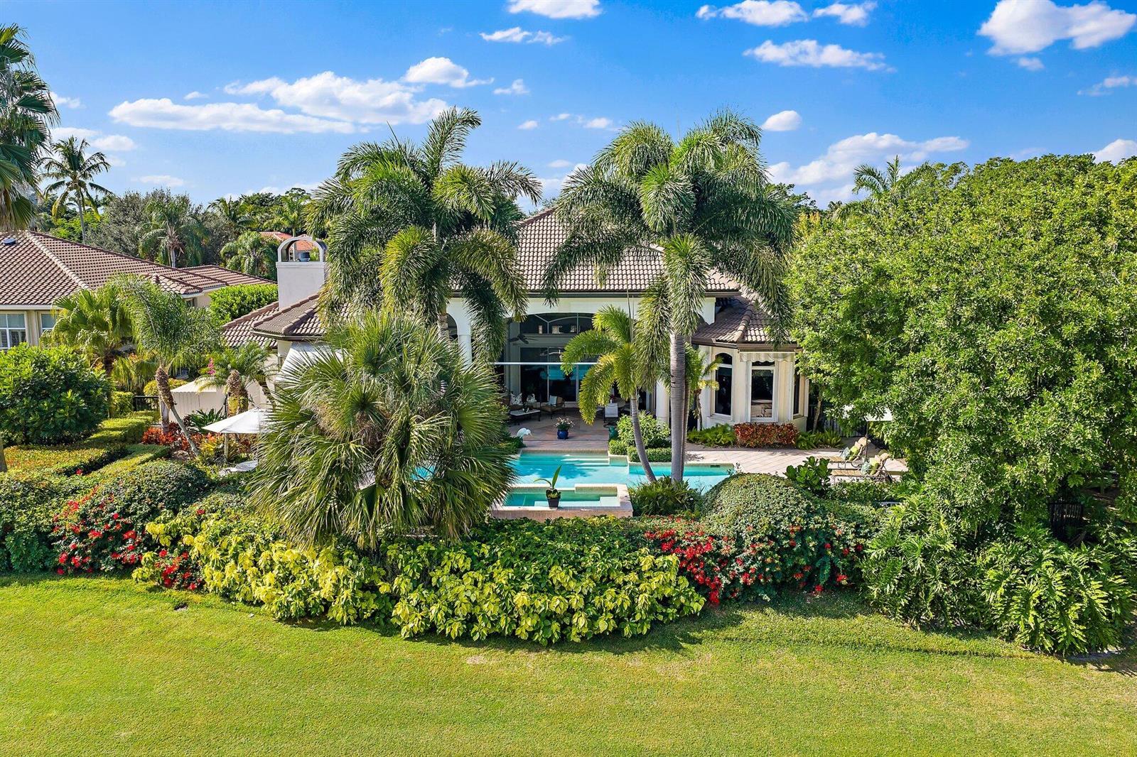 An aerial view of a house with a swimming pool, palm trees, and lush landscaping — 8010 Fairway Lane, West Palm Beach FL 33412, WEST PALM BEACH, FL