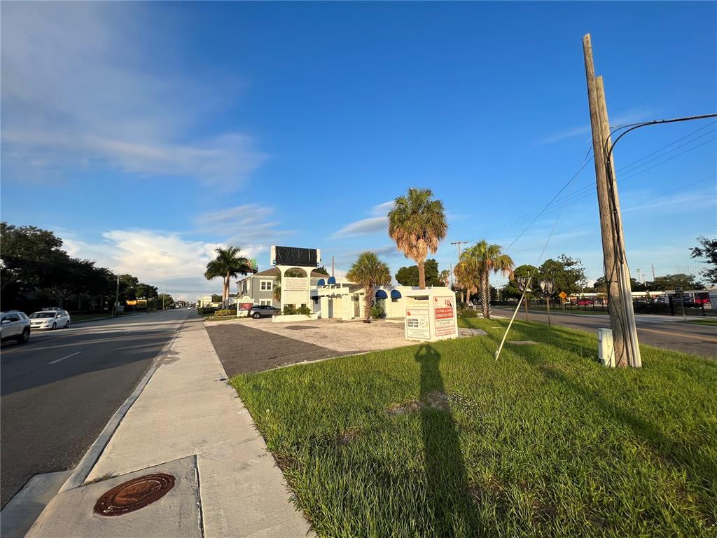 A paved lot with a small building, palm trees, and a donation bin — 3901 HENDERSON BOULEVARD, TAMPA, FL