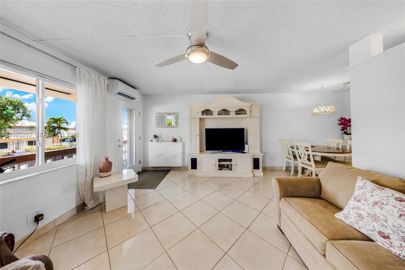 A living room with tile floors, a ceiling fan, a television console, and dining area — 1015 SW 11th Ave # 15K, Hallandale Beach FL 33009, HALLANDALE BEACH, FL