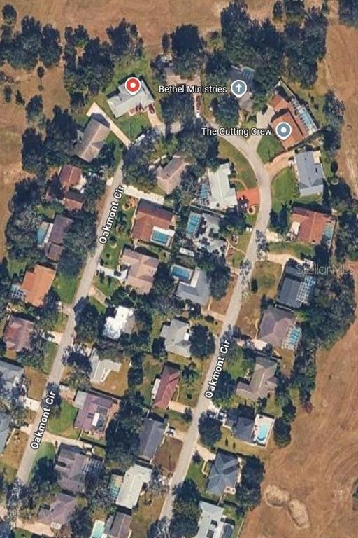 This is an aerial map view of a residential neighborhood with houses along Oakmont Circle — 34 OAKMONT CIRCLE, ORMOND BEACH, FL
