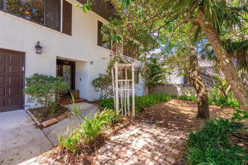 A white two-story house exterior features a brown garage door, front entryway, and landscaped yard — 40 CONCORD DRIVE, ORMOND BEACH, FL