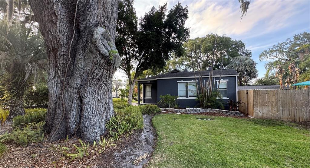A dark gray house stands behind a large tree and a grassy yard — 795 30TH STREET, ORLANDO, FL
