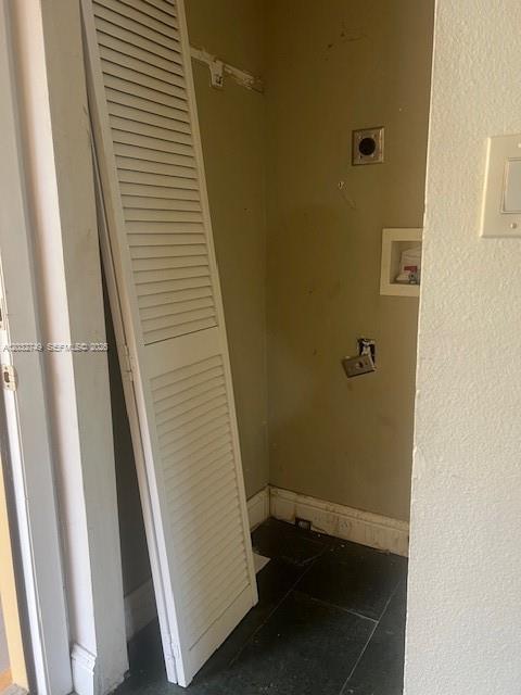 A small utility closet with a louvered door leaning against the wall and exposed plumbing — 17911 NW 68th Ave # P208, Hialeah FL 33015, HIALEAH, FL