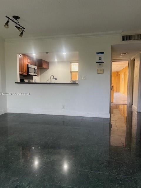 A kitchen with wooden cabinets and a pass-through window overlooks a room with dark flooring — 17911 NW 68th Ave # P208, Hialeah FL 33015, HIALEAH, FL
