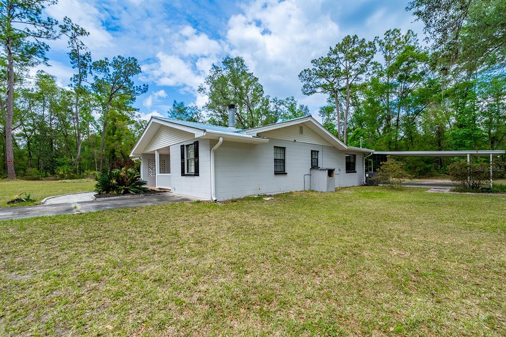 A light gray single-story house with a metal roof and an attached carport — 1753 SE HIGHWAY 349, OLD TOWN, FL