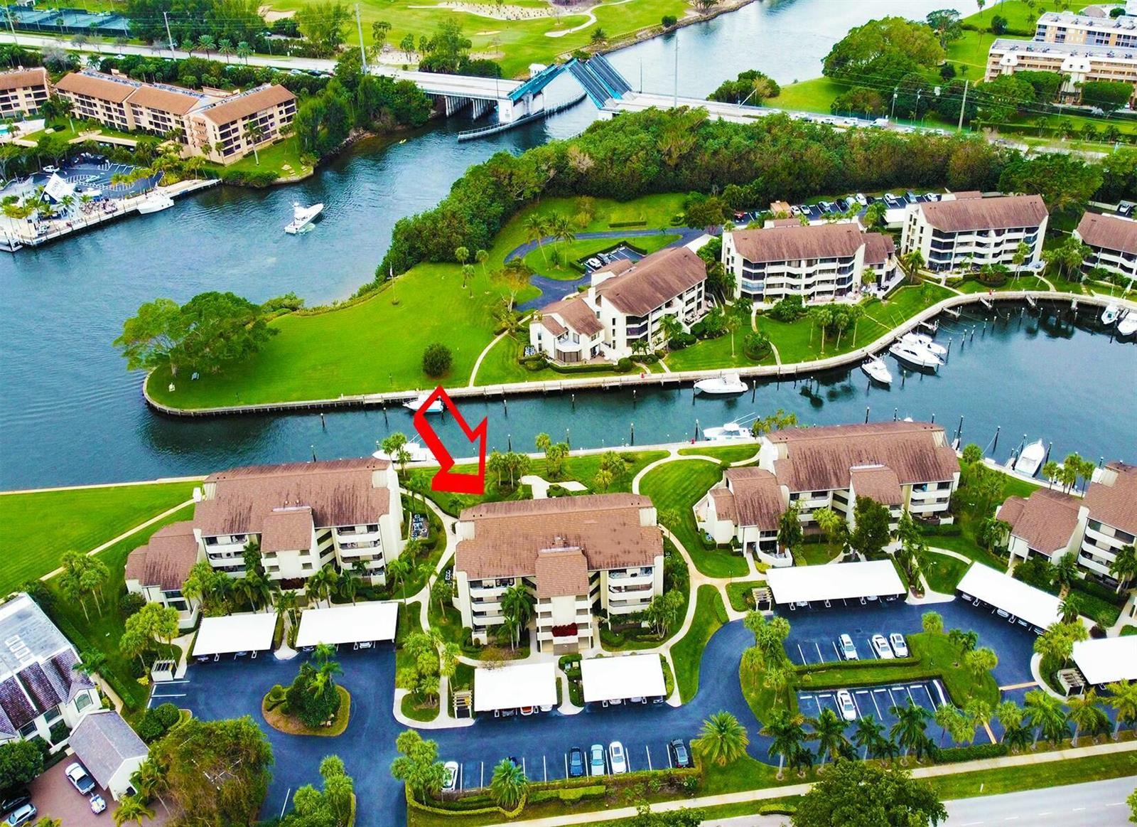 An aerial view shows a multi-story condominium complex with a red arrow pointing toward it — 1117 Marine Way E, North Palm Beach FL 33408, NORTH PALM BEACH, FL