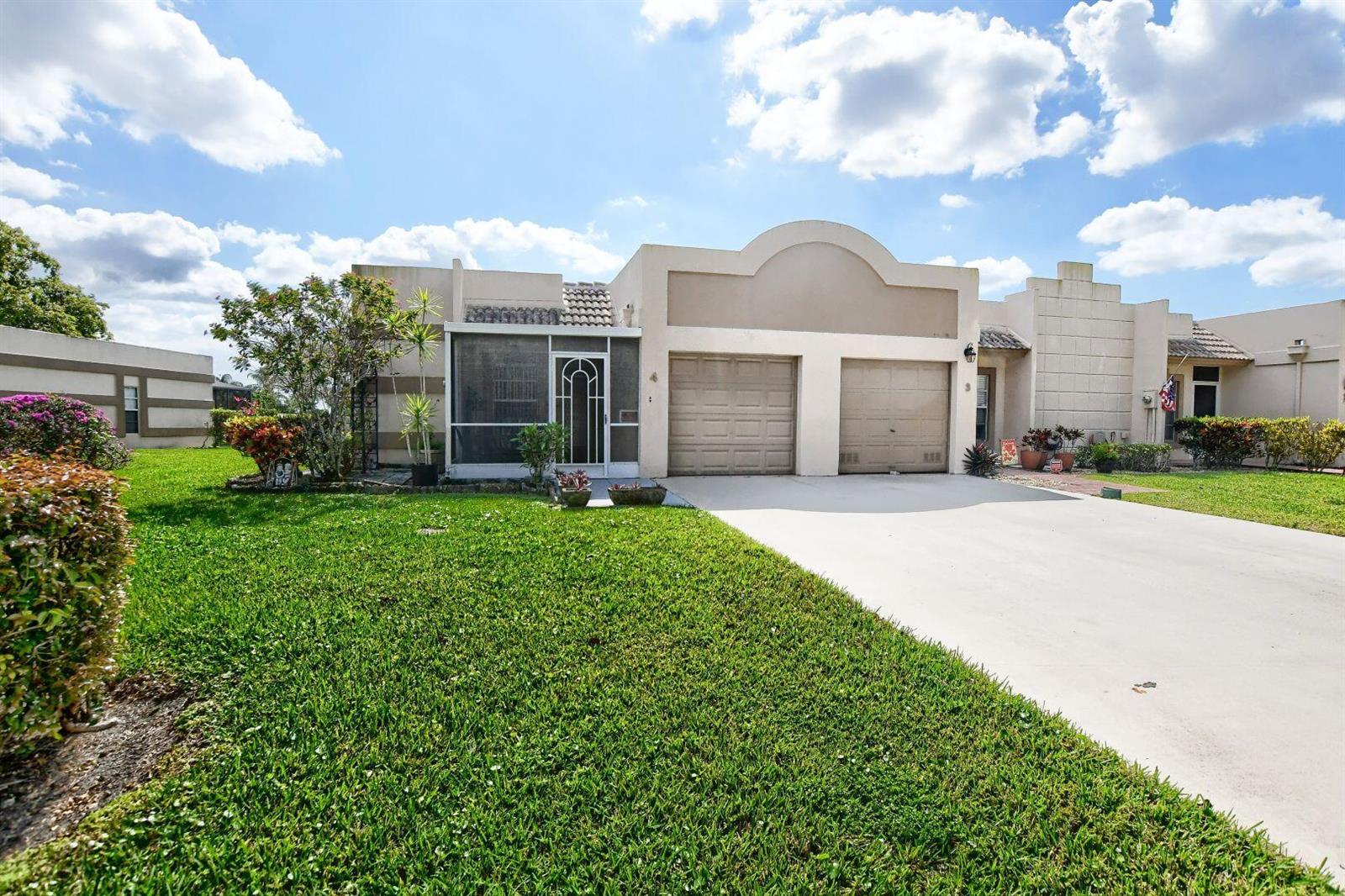 A single-story house with a two-car garage, a screened-in porch, and a grassy front lawn — 9244 Flynn Circle # 4, Boca Raton FL 33496, BOCA RATON, FL