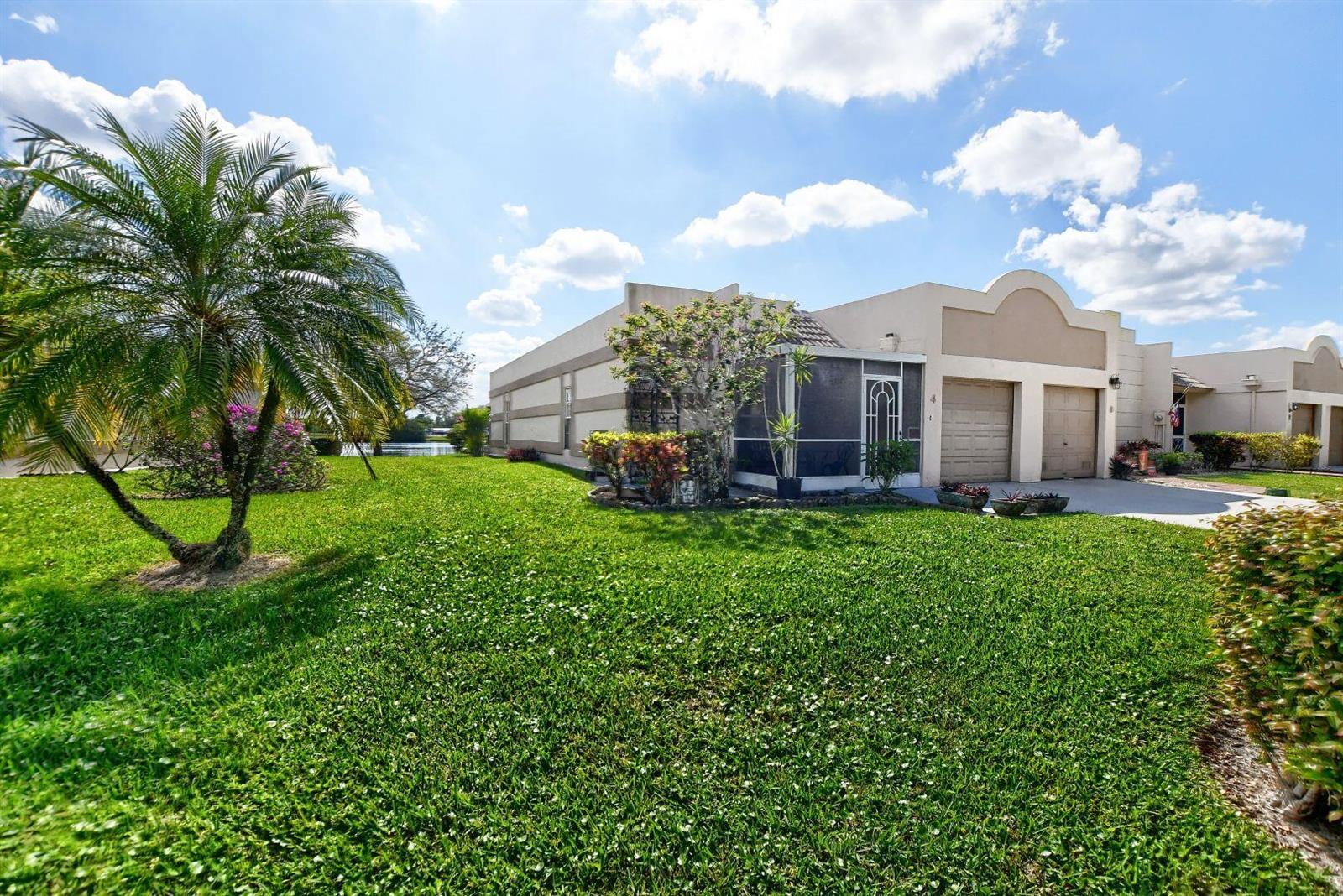 A single-story house with a two-car garage, screened patio, and a large grassy front yard — 9244 Flynn Circle # 4, Boca Raton FL 33496, BOCA RATON, FL